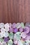 Fluorite stones heap texture on brown varnished wood background. Place for text