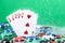 Flush poker combination under the water drops and falling poker chips against green background. Online gambling. Betting.