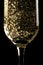 Flute of champagne with golden bubbles