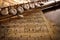 Flute and old handwritten sheet music on black table elevated