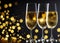 flutes with champagne or fizzy white wine on black background with blurred sparkles in the back