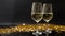 flutes with champagne or fizzy white wine on black background with blurred sparkles in the back