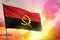 Fluttering Angola flag on beautiful colorful sunset or sunrise background. Success concept