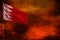 Fluttering Bahrain flag mockup with blank space for your text on crimson red sky with smoke pillars background. Troubles concept