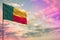 Fluttering Benin flag mockup with the space for your content on colorful cloudy sky background