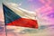 Fluttering Czechia flag on colorful cloudy sky background. Prosperity concept