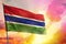 Fluttering Gambia flag on beautiful colorful sunset or sunrise background. Success concept