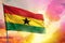 Fluttering Ghana flag on beautiful colorful sunset or sunrise background. Success concept