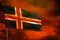 Fluttering Iceland flag on crimson red sky with smoke pillars background. Troubles concept