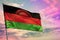 Fluttering Malawi flag on colorful cloudy sky background. Prosperity concept