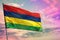 Fluttering Mauritius flag on colorful cloudy sky background. Prosperity concept.