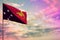 Fluttering Papua New Guinea flag mockup with the space for your content on colorful cloudy sky background