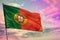 Fluttering Portugal flag on colorful cloudy sky background. Prosperity concept