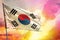 Fluttering Republic of Korea South Korea flag on beautiful colorful sunset or sunrise background. Success concept.
