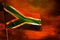 Fluttering South Africa flag on crimson red sky with smoke pillars background. Troubles concept