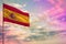 Fluttering Spain flag mockup with the space for your content on colorful cloudy sky background