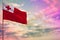 Fluttering Tonga flag mockup with the space for your content on colorful cloudy sky background