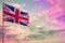 Fluttering United Kingdom UK flag mockup with the space for your content on colorful cloudy sky background.