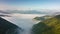 Fly above foggy clouds in mountains valley Time lapse