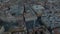 Fly above large city at sunset. Zoomed aerial footage of historic buildings and towers, Monumental St. Peters Basilica