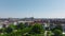 Fly above park in city. Panoramic view of town development, apartment houses and large church tower. Copenhagen, Denmark