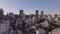 Fly above residential urban neighborhood in metropolis. Multistorey apartment buildings in city. Tokyo, Japan