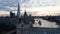 Fly around top walkway and roof of Tower Bridge. Evening panoramic view of skyscrapers on River Thames banks. London, UK