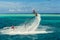 Fly board rider doing trick and having fun in blue sea. Extreme sport background