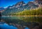 Fly fisherman casts in lake in Grand Teton National Park