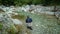 A fly fisherman fishing a small alpine stream in Slovenia for Marble Trout