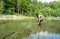 Fly fisherman flyfishing in river