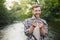 Fly-fisherman holding trout out of the water