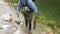 Fly fisherman picking up large trout