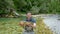 A fly fisherman proudly holding a rare Marble Trout from the Soca River