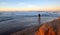 Fly fisherman at sunrise at Santa Clara river tidal inlet at McGrath State Park in Ventura California USA