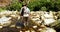 Fly fisherman walking in river with fishing rod