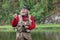 fly fishing fisherman tying fly of fishing hook on fishing rod