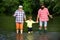 Fly fishing for trout. Old and young. Portrait of happy little son, father and grandfather - three generations of men