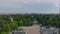 Fly over Arco della Pace on Piazza Sempione. Aerial view of green deciduous trees in Sempione Park. Milano, Italy