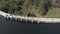 Fly over barrage in Munnar, India. People and cars crossing over.