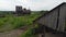 Fly over dirty road through abandoned village and granary