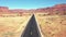 Fly Over Highway In Usa Desert Among Red Rocks Formation Aerial View