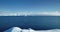 Fly over massive snow covered iceberg drift ocean