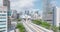 Fly over Metromover track leading on columns above park. Modern passenger transport vehicle in metropolis. Miami, USA