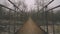 Fly Run Walk Over Old Metal Rope Cable Bridge Over Rocky River In Winter Foggy Mist Day Cinematic Colored Wide Angle View