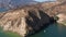 Flyby footage of a boat cruising emerald waters of Castaic lake near Los Angeles on a beautiful sunny day, 4k aerial