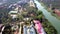 Flycam hangs above Buddhist monastery complex on river bank