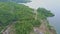 Flycam Shows Quiet River with Tropical Forest and Road on Bank