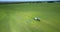 Flycam upper view vast fields with trailed sprayer