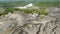 Flying above the abandoned clay quarry with canyons and cracks